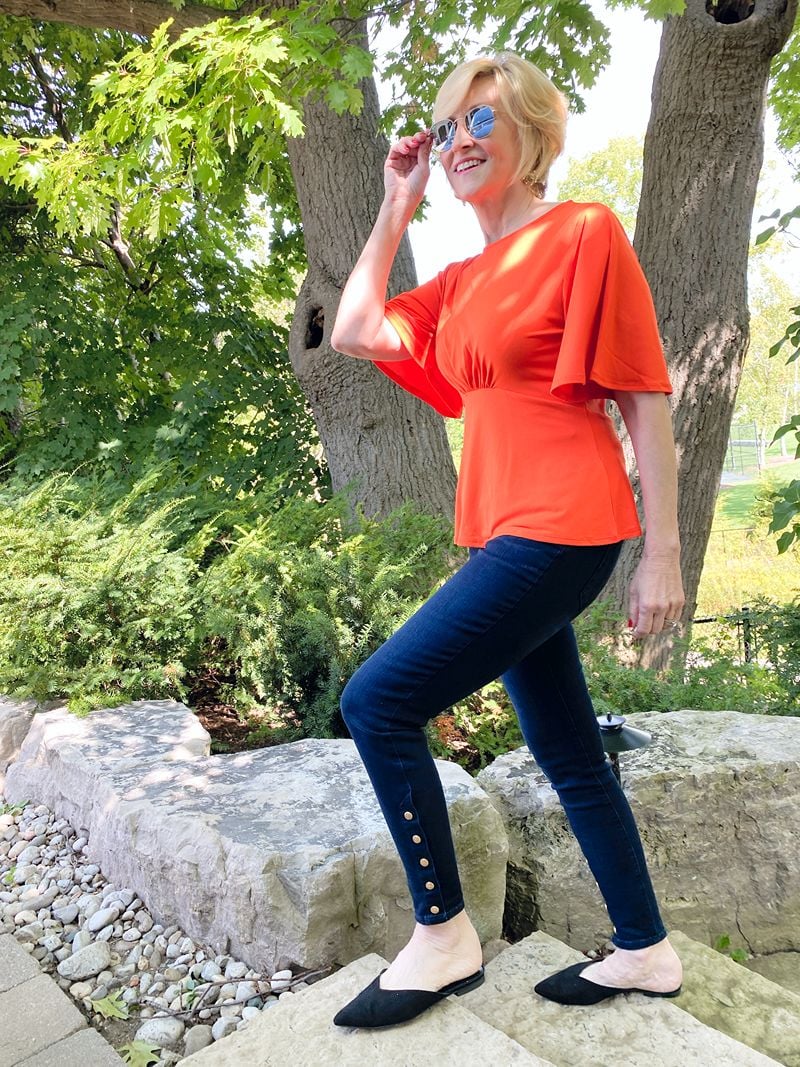 jeggings with buttons, orange top worn by Deborah Boland from Fabulous After 40