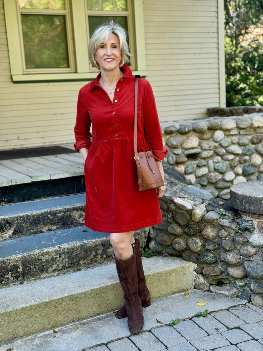 rust corduroy dress with suede chocolate brown boots, and cogna leather bucket bag.